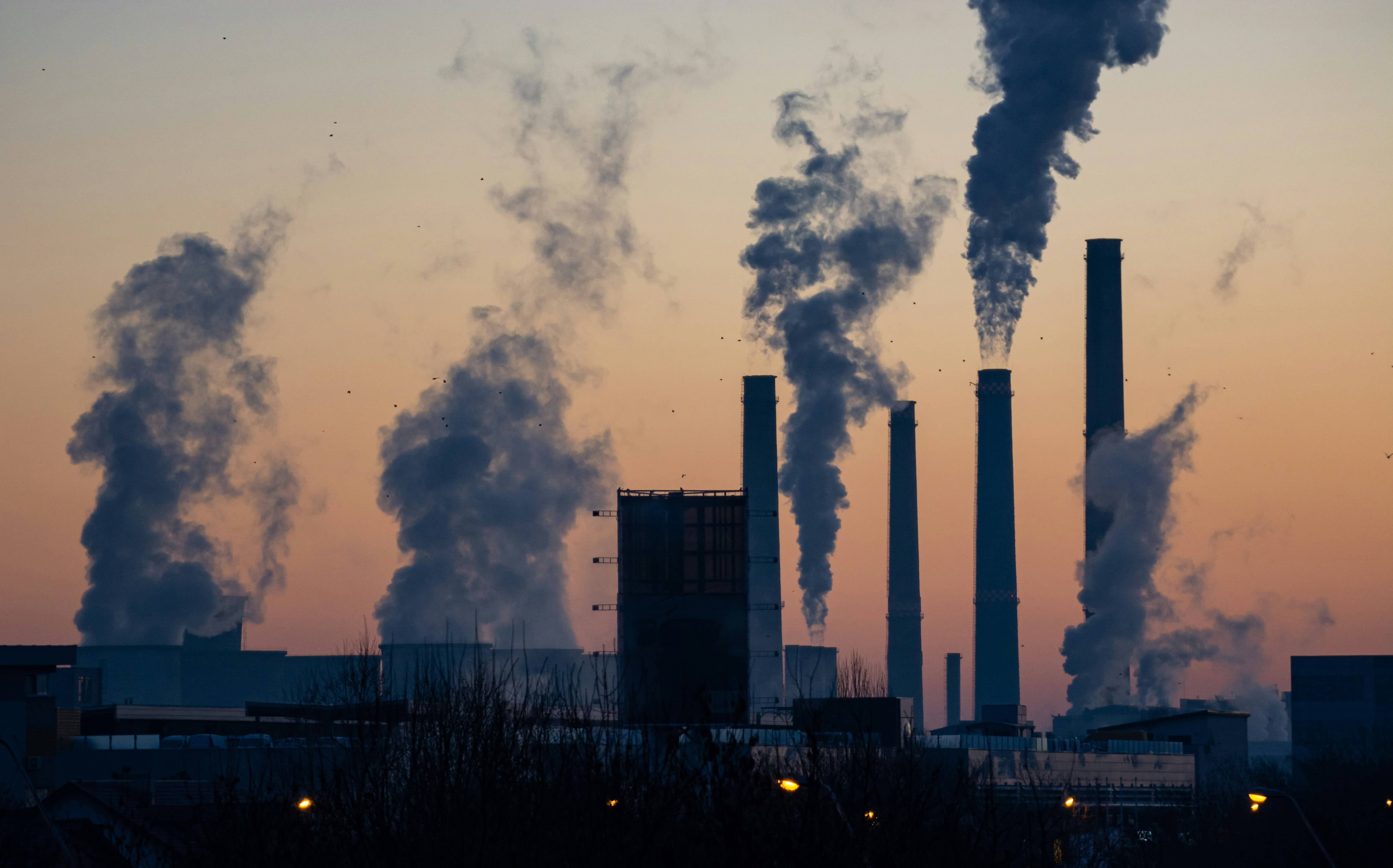 Power plant with sun setting.